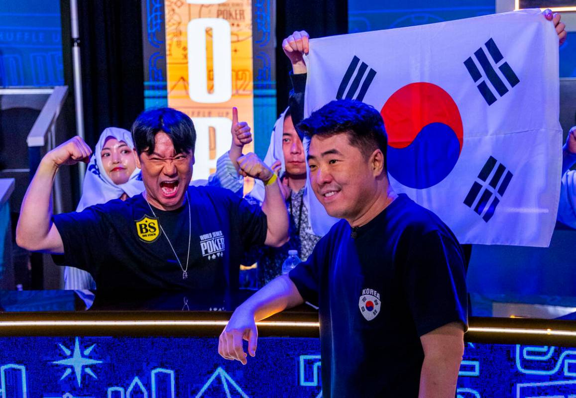 Daehyung Lee of Seoul, South Korea, hangs out with supporters on the rail at the final table du ...