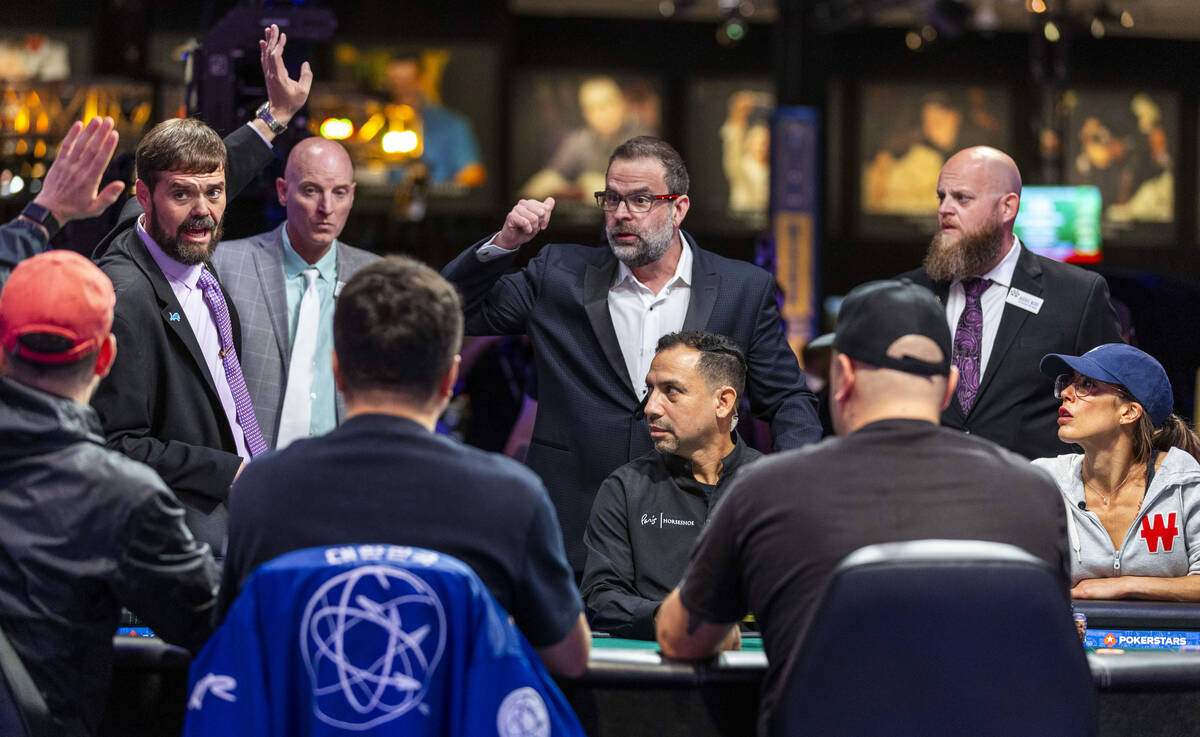 Jack Effel, World Series of Poker vice president, discusses some rules with competitors at the ...