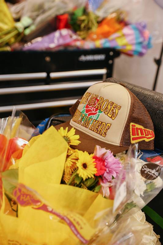 A hat and many flowers decorate the memorial set up at Michael Simmons’ chair at Faded Barber ...
