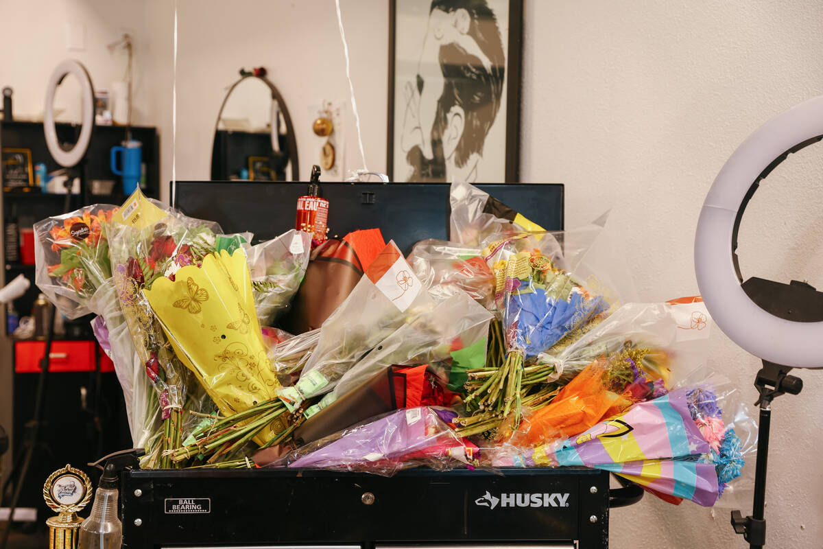 Bouquets of flowers fill the barber station around the memorial set up at Michael Simmons&#x201 ...