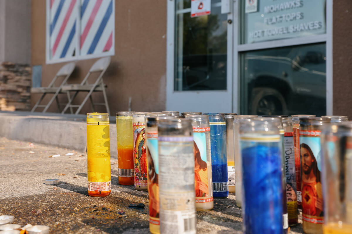 Candles placed in memory of Michael Simmons sit outside Faded Barber Shop on Tuesday, July 15, ...