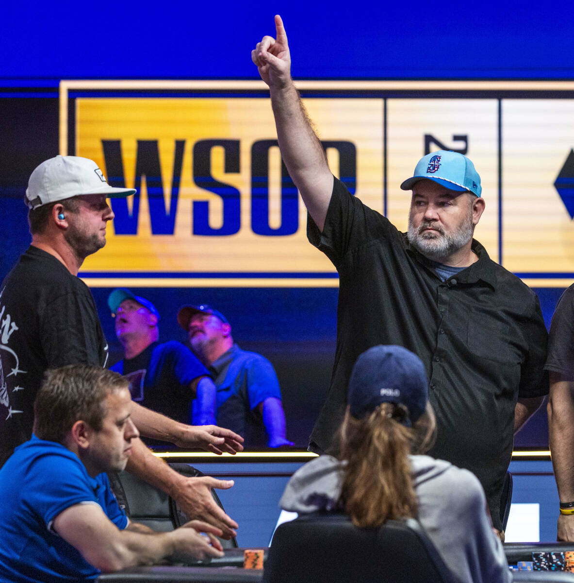 John Wasnock of North Bend, Washington celebrates a pot win as Daehyung Lee of Seoul, South Kor ...