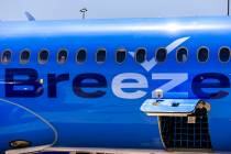 A Breeze Airways passenger looks out the window as their inaugural flight arrival makes it to t ...