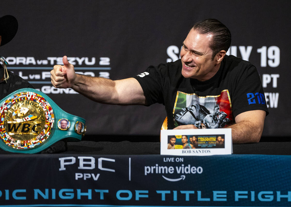 Trainer Bob Santos signals someone in the crowd during a press conference for the upcoming figh ...