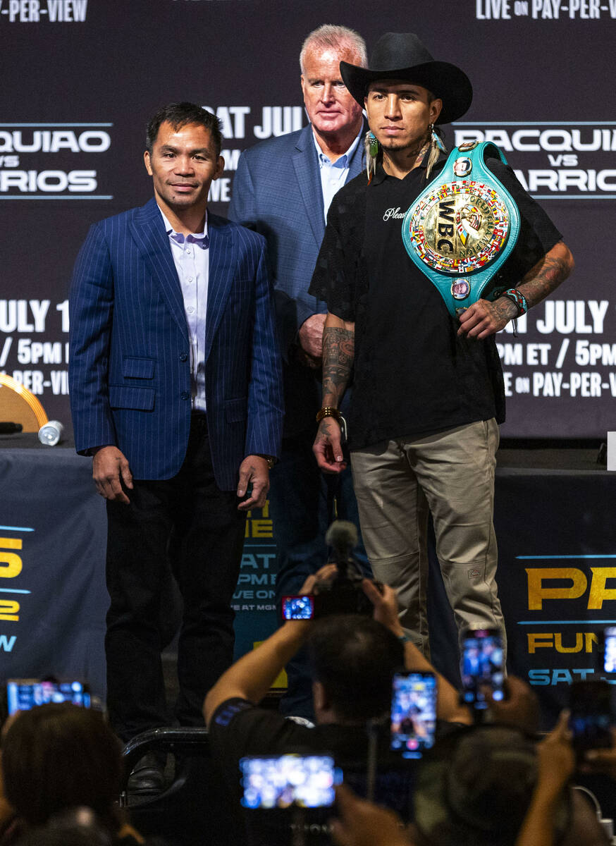 Manny Pacquiao and Mario Barrios stand for the crowd with promoter Tom Brown in between during ...