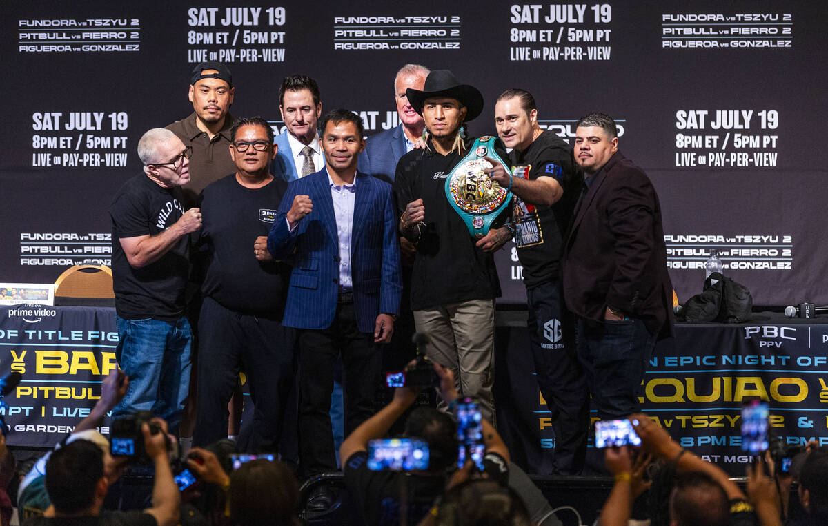 Manny Pacquiao and Mario Barrios face the crowd with their teams and others during a press conf ...