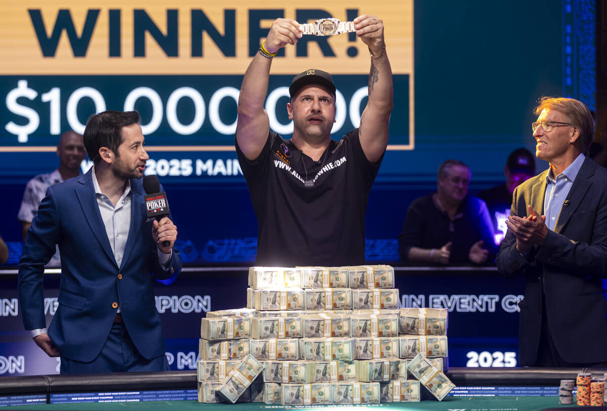Michael Mizrachi, center, poses with the World Series of Poker Main Event bracelet after winnin ...