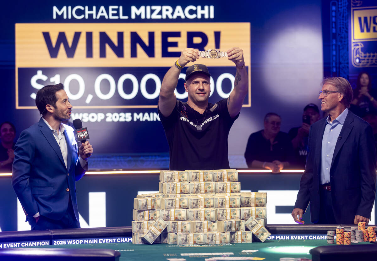 Michael Mizrachi, center, poses with the World Series of Poker Main Event bracelet after winnin ...