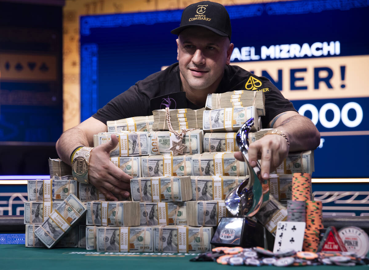 Michael Mizrachi poses with his World Series of Poker Main Event winnings - including the champ ...