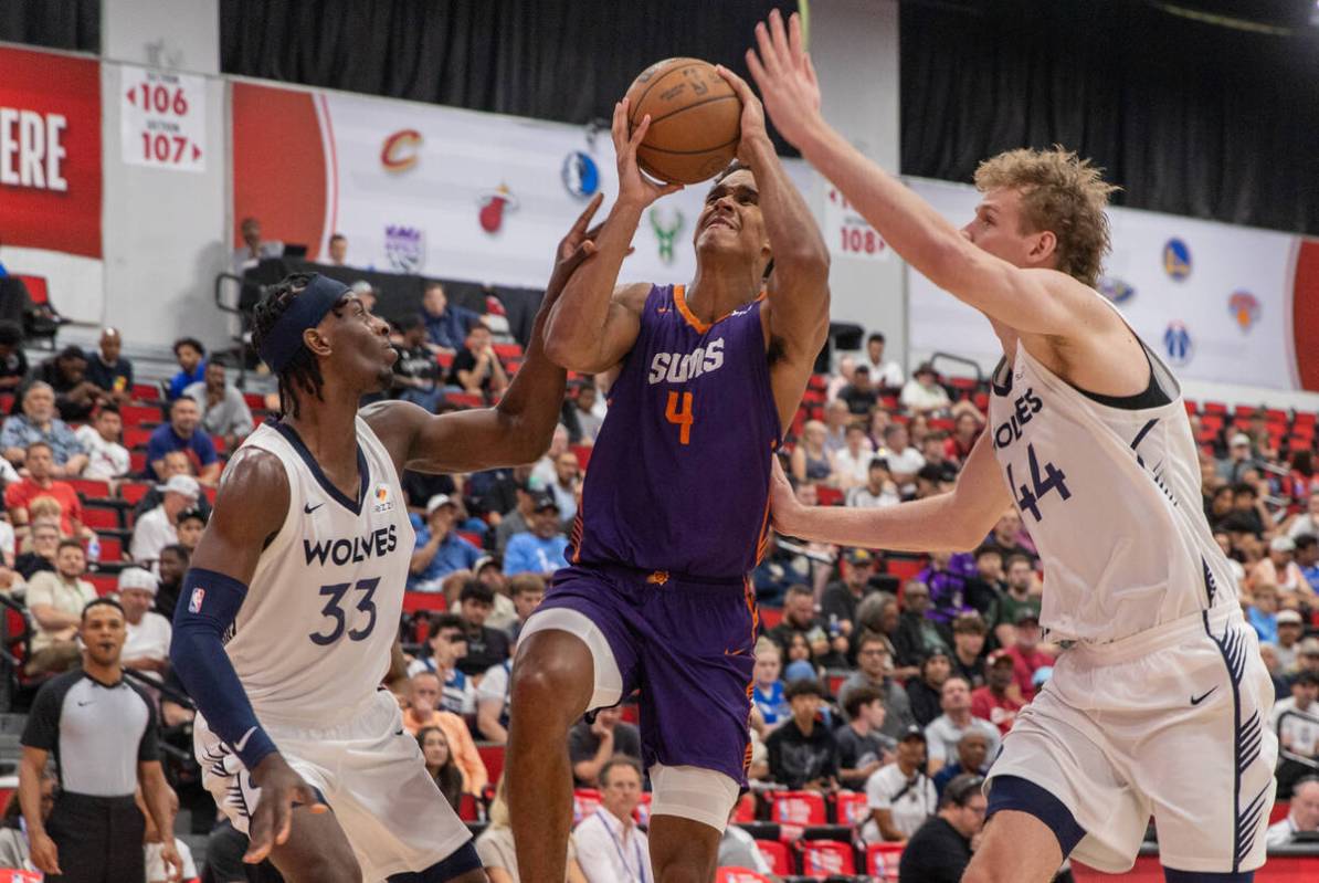 Oso Ighodaro (4) of the Phoenix Suns makes a layup while being defended by the Minnesota Timber ...