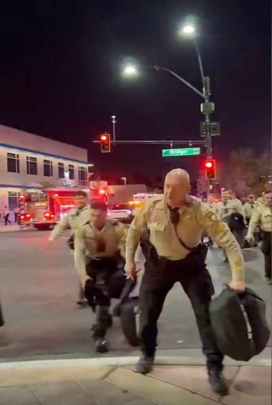 This video screenshot shows Metro officers approaching Karlin Martinez and Cesar Corrales to ma ...