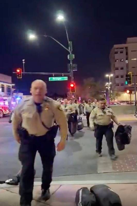 This video screenshot shows Metro officers approaching Karlin Martinez and Cesar Corrales to ma ...