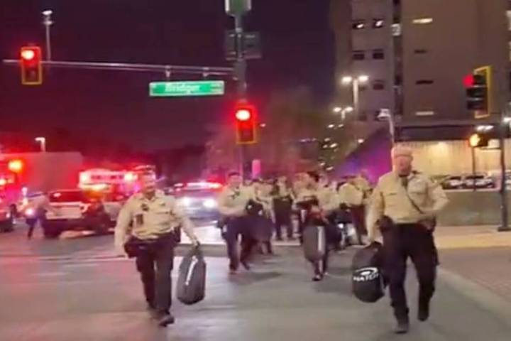 This video screenshot shows Metro officers approaching Karlin Martinez and Cesar Corrales to ma ...
