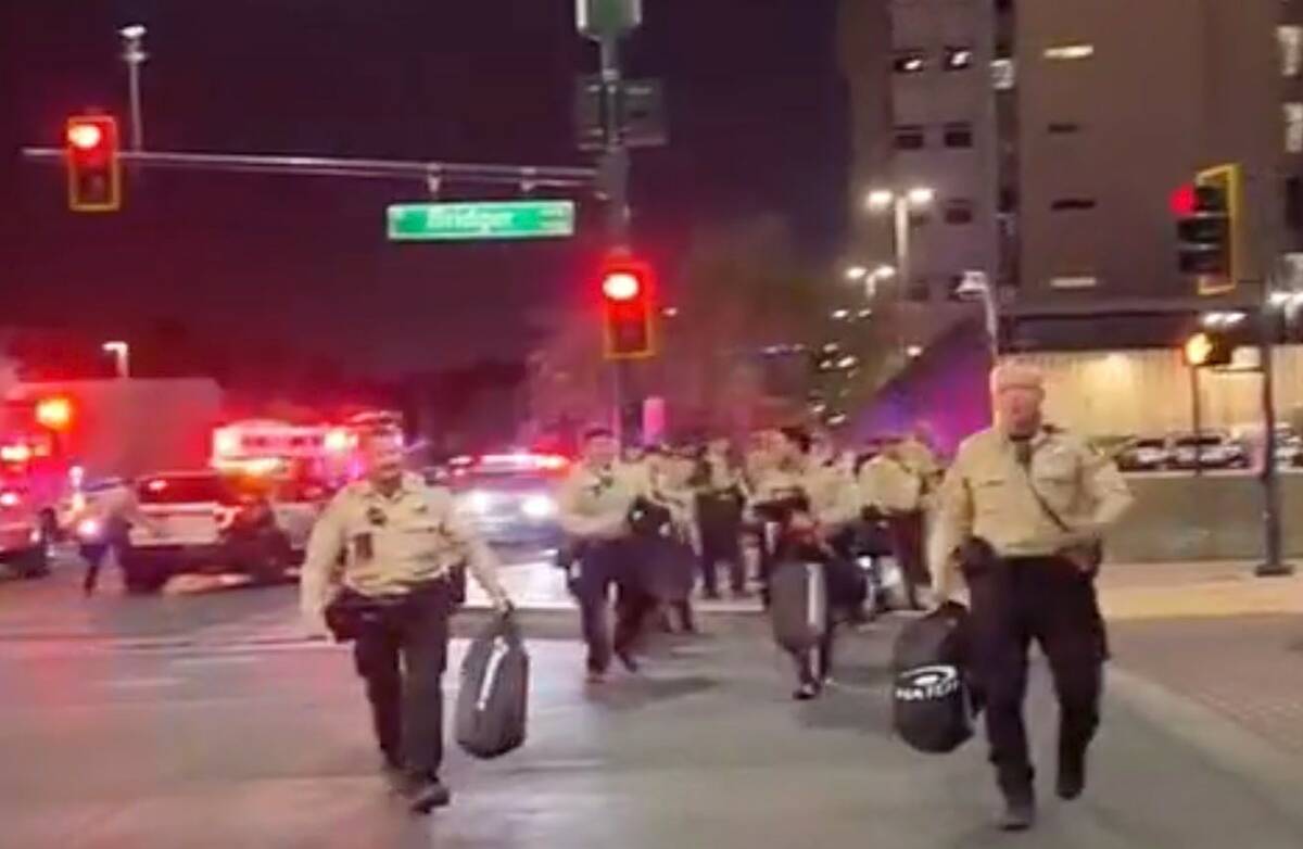 This video screenshot shows Metro officers approaching Karlin Martinez and Cesar Corrales to ma ...