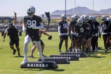 Raiders defensive end Maxx Crosby (98) leads the team during a drill as Raiders defensive end T ...