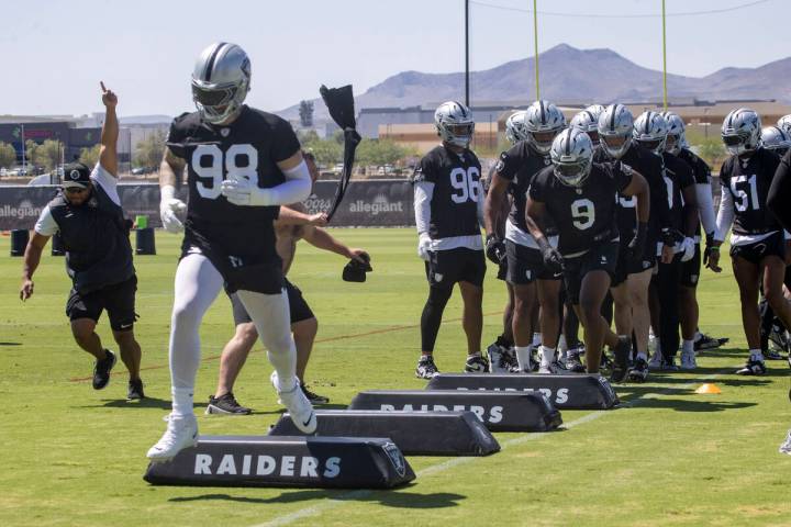 Raiders defensive end Maxx Crosby (98) leads the team during a drill as Raiders defensive end T ...