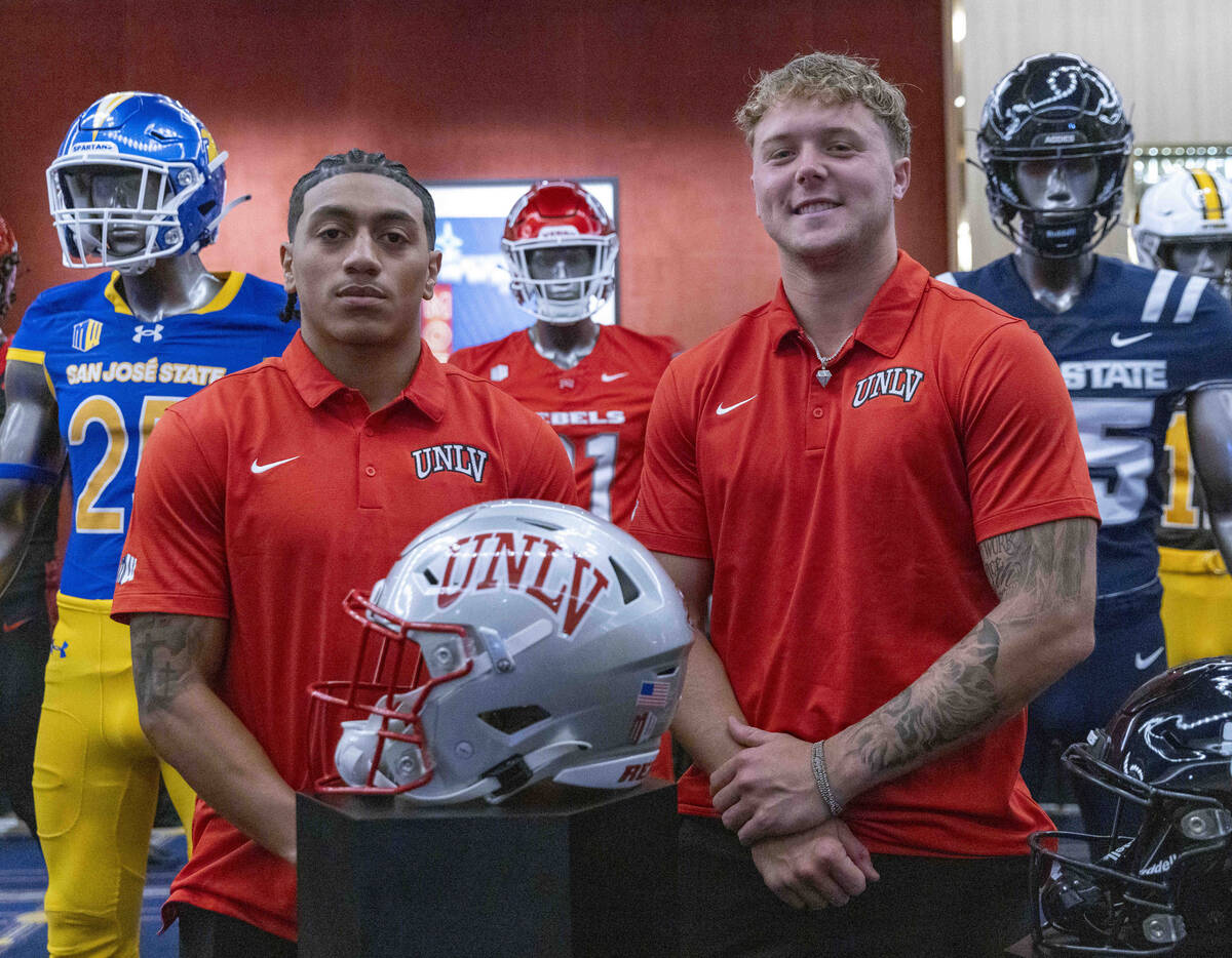 UNLV football wide receiver DeAngelo Irvin Jr., left, and safety Jake Pope pose for a photo dur ...