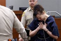 Devyn Michaels who is accused of killing her boyfriend is led out of a courtroom after protesti ...