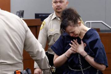 Devyn Michaels who is accused of killing her boyfriend is led out of a courtroom after protesti ...
