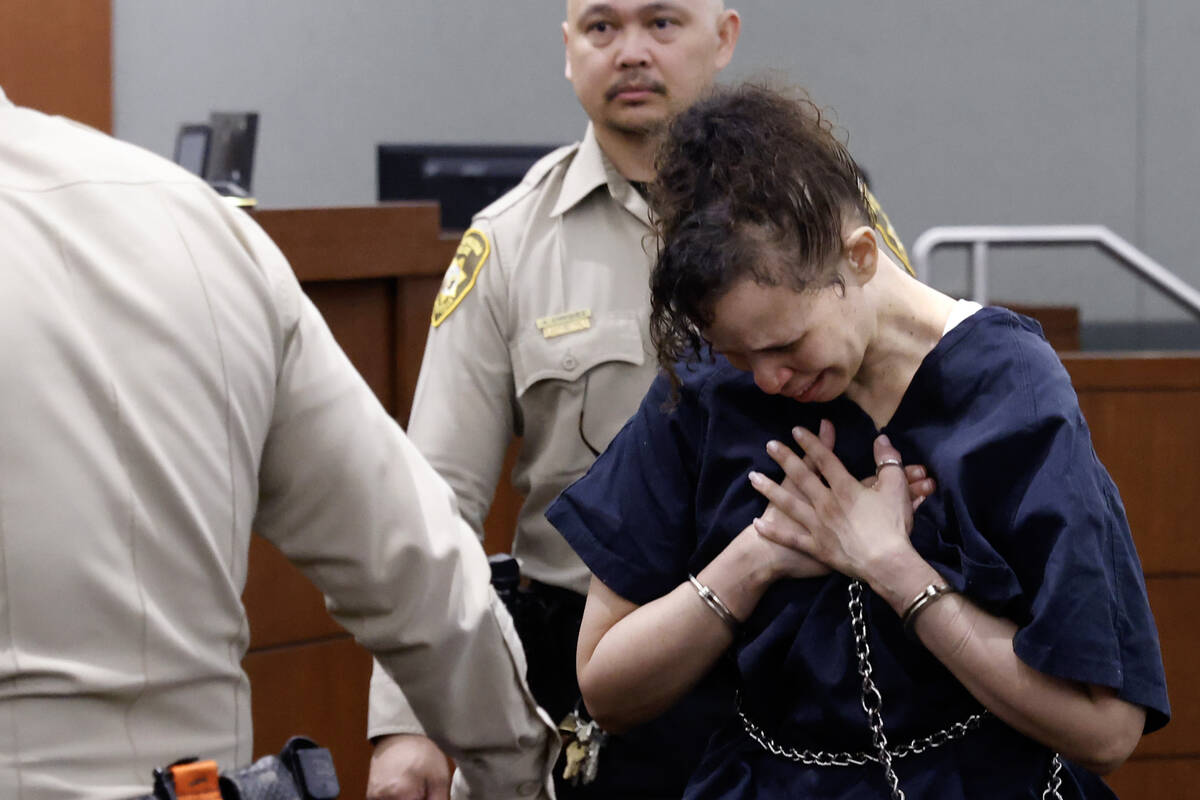 Devyn Michaels who is accused of killing her boyfriend is led out of a courtroom after protesti ...
