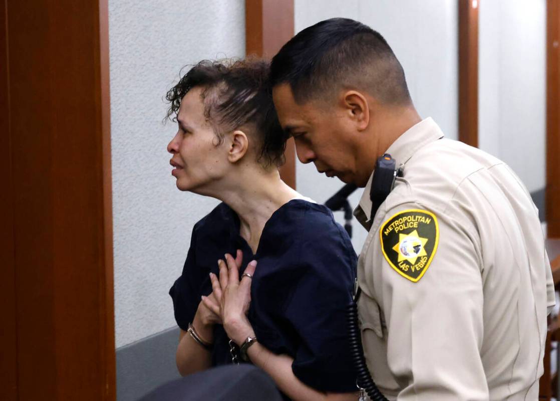 Devyn Michaels, who is accused of killing her boyfriend, is led out of a courtroom after protes ...