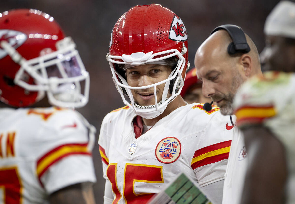 Kansas City Chiefs quarterback Patrick Mahomes (15) smiles while in a huddle during the second ...