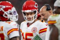 Kansas City Chiefs quarterback Patrick Mahomes (15) smiles while in a huddle during the second ...