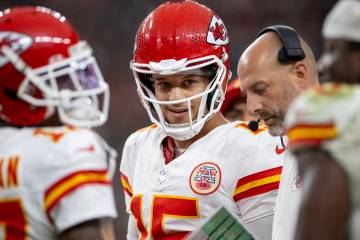 Kansas City Chiefs quarterback Patrick Mahomes (15) smiles while in a huddle during the second ...