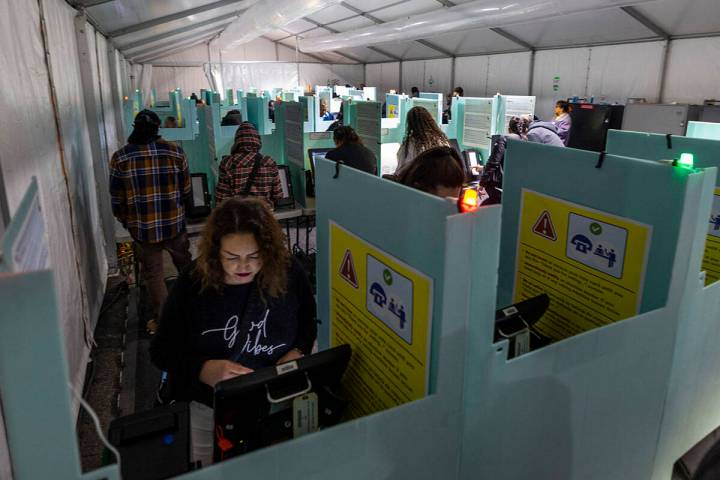 People cast their ballots on Election Day at the Nellis Crossing Shopping Mall on Tuesday, Nov. ...