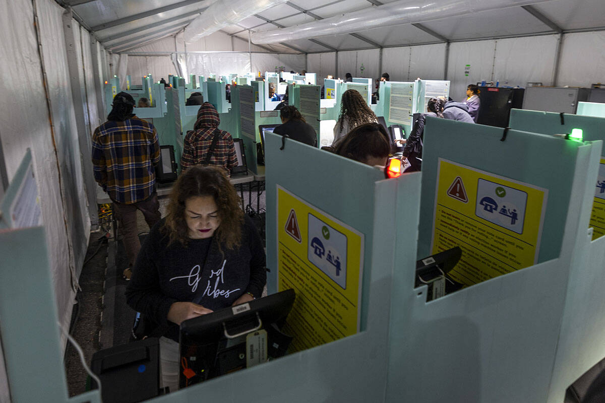 People cast their ballots on Election Day at the Nellis Crossing Shopping Mall on Tuesday, Nov. ...