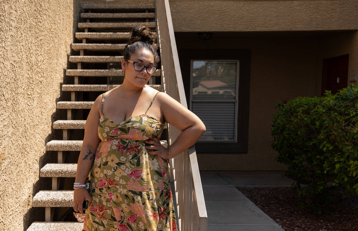 Ashley Webster stands outside her Las Vegas apartment July 15, 2025. With no central air inside ...