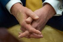 President Donald Trump sits with his hands interlocked as he and Bahrain's Crown Prince Salman ...