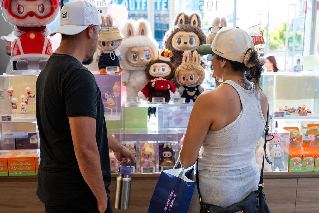 Customers look at Labubu dolls on display at Pop Mart’s new store in Las Vegas July 12, ...