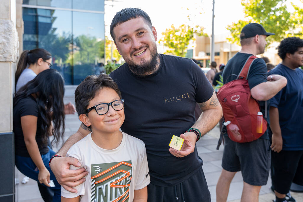 Rudy Gonzalez waits with his nephew Aidan Barron, 10, after arriving at 11 p.m. Friday night ou ...