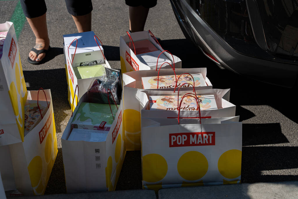 Customers organize their purchases after visiting Pop Mart’s new store in Las Vegas July ...