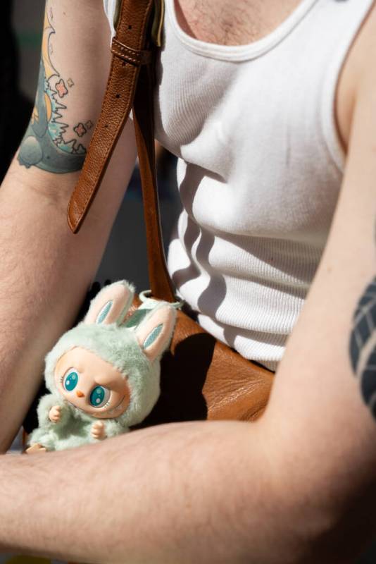 John Giangrande waits while his partner Lauren Frixione organizes their purchases after visitin ...