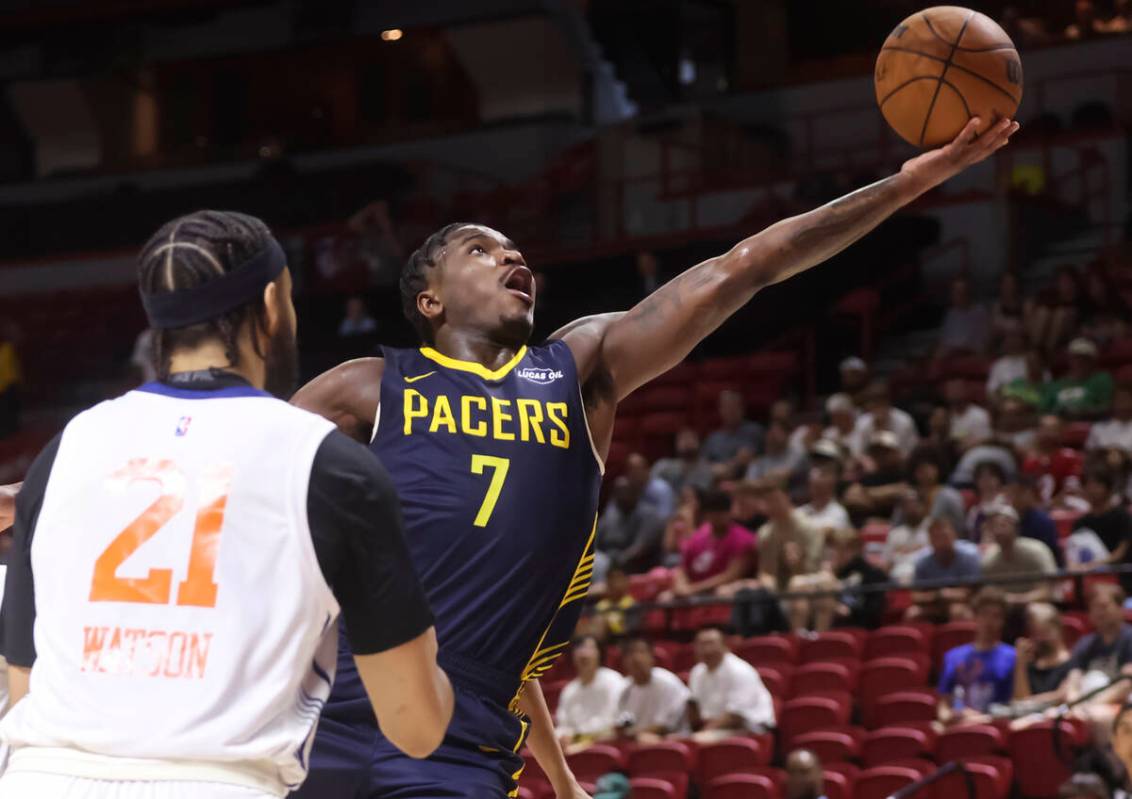Indiana Pacers guard Cam Jones (7) attempts a layup under pressure from New York Knicks forward ...