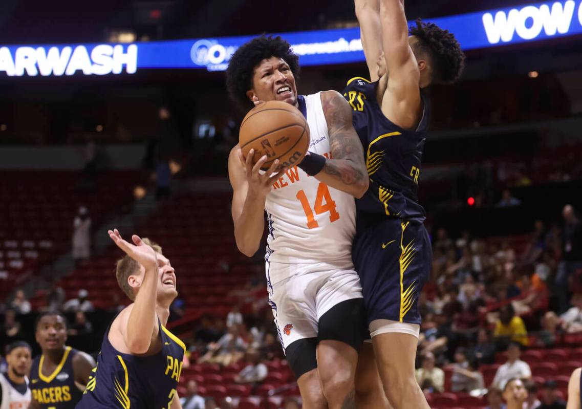 New York Knicks forward MarJon Beauchamp (14) tries to shoot around Indiana Pacers forward Enri ...