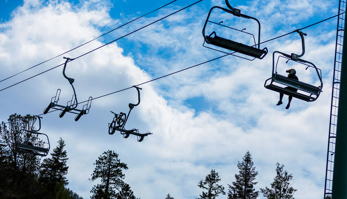 A bike and rider take the chair lift to the starting line up top during the Viva La Gravity at ...