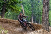 Women's open rider Renee Shimada navigates a banked turn in the rain during the Viva La Gravity ...
