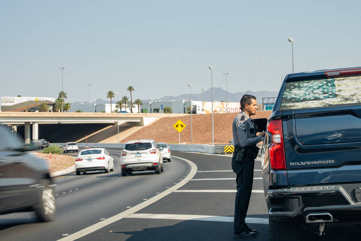 Luis Villanueva, a sworn recruiter with the Nevada Highway Patrol, returns to a vehicle to issu ...