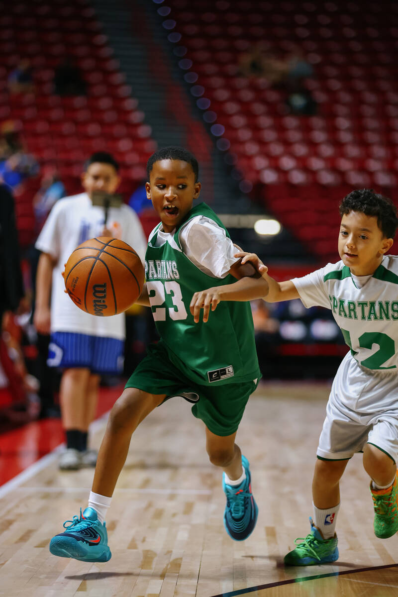 Members of Clark County’s Spartan Basketball Academy play a short game during halftime o ...