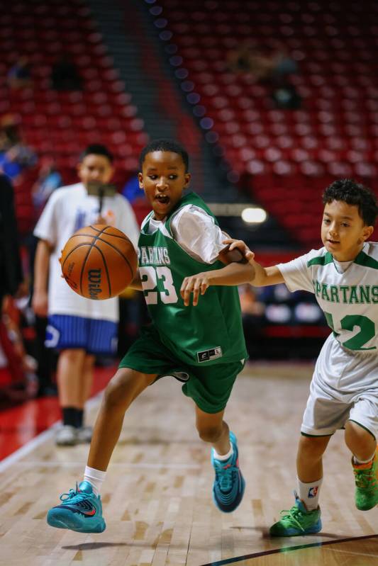 Members of Clark County’s Spartan Basketball Academy play a short game during halftime o ...