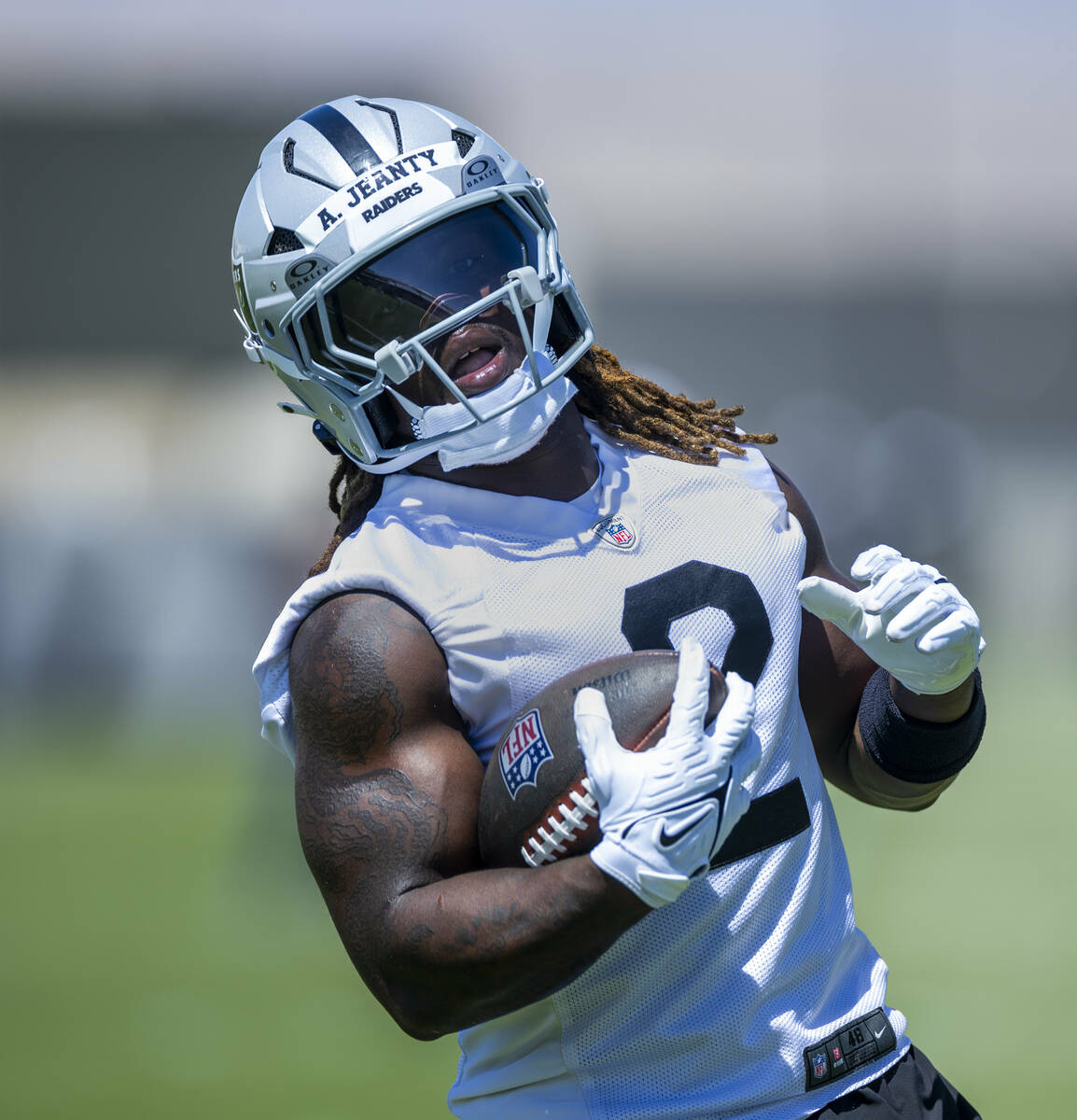 Raiders running back Ashton Jeanty (2) runs the ball up the field during Raiders OTA practice a ...