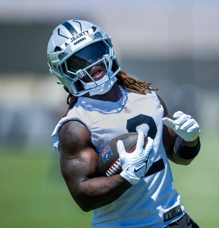 Raiders running back Ashton Jeanty (2) runs the ball up the field during Raiders OTA practice a ...
