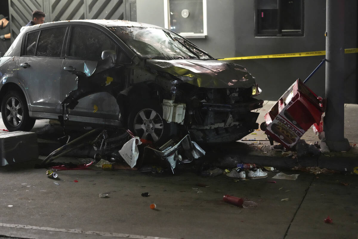 A vehicle sits on the sidewalk after ramming into a crowd of people waiting to enter a nightclu ...
