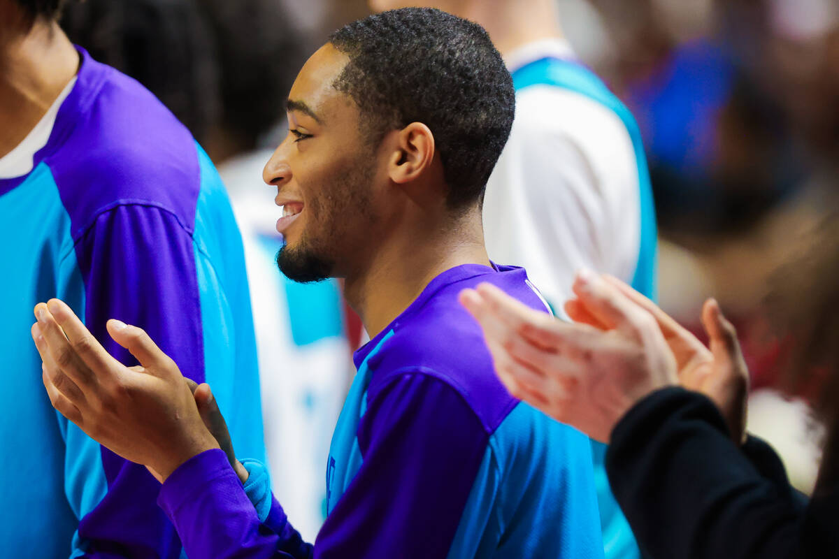 Charlotte Hornets guard Dajuan Harris Jr. claps from the bench during an NBA Summer League semi ...