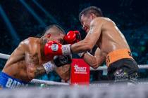 Mario Barrios and Manny Pacquiao trade punches during their WBC welterweight championship fight ...