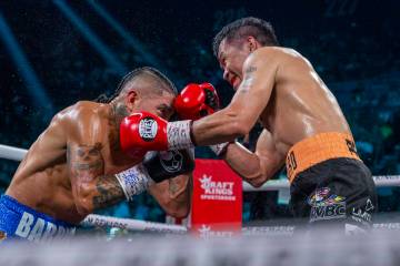 Mario Barrios and Manny Pacquiao trade punches during their WBC welterweight championship fight ...