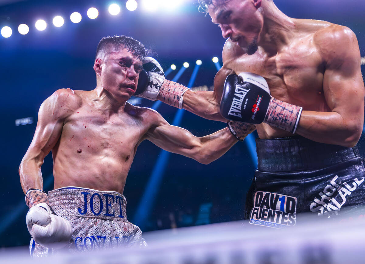 Joet Gonzalez takes a punch to the head from Brandon Figueroa during their WBA featherweight ti ...